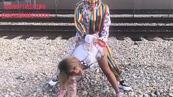 Clown fucks girl on train tracks