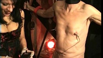 Dirty slave gets large meat hooks through is nipples and gets spanked by latex wearing mistress