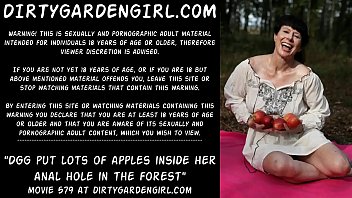 Dirtygardengirl put lots of apples inside her anal hole in the forest